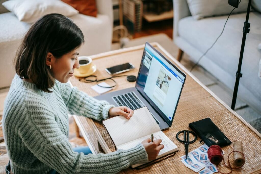 A woman taking notes from her laptop