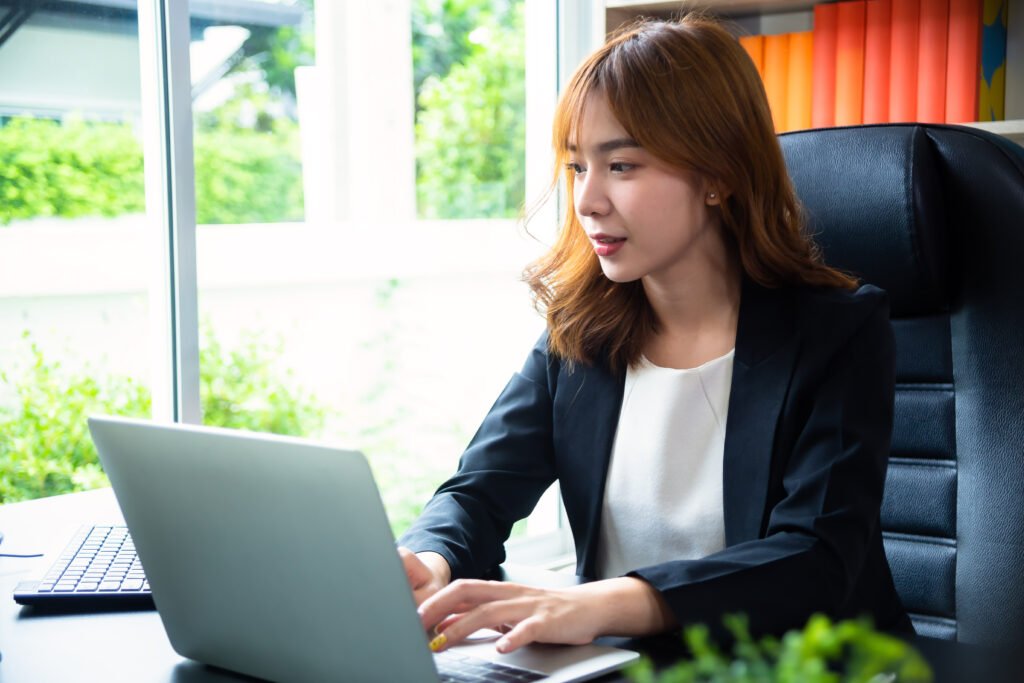 a woman using a laptop for digital marketing service