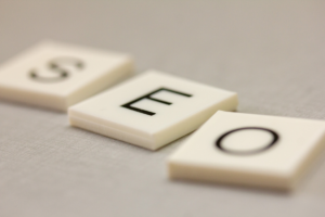 White square cubes spelling "SEO" on a surface