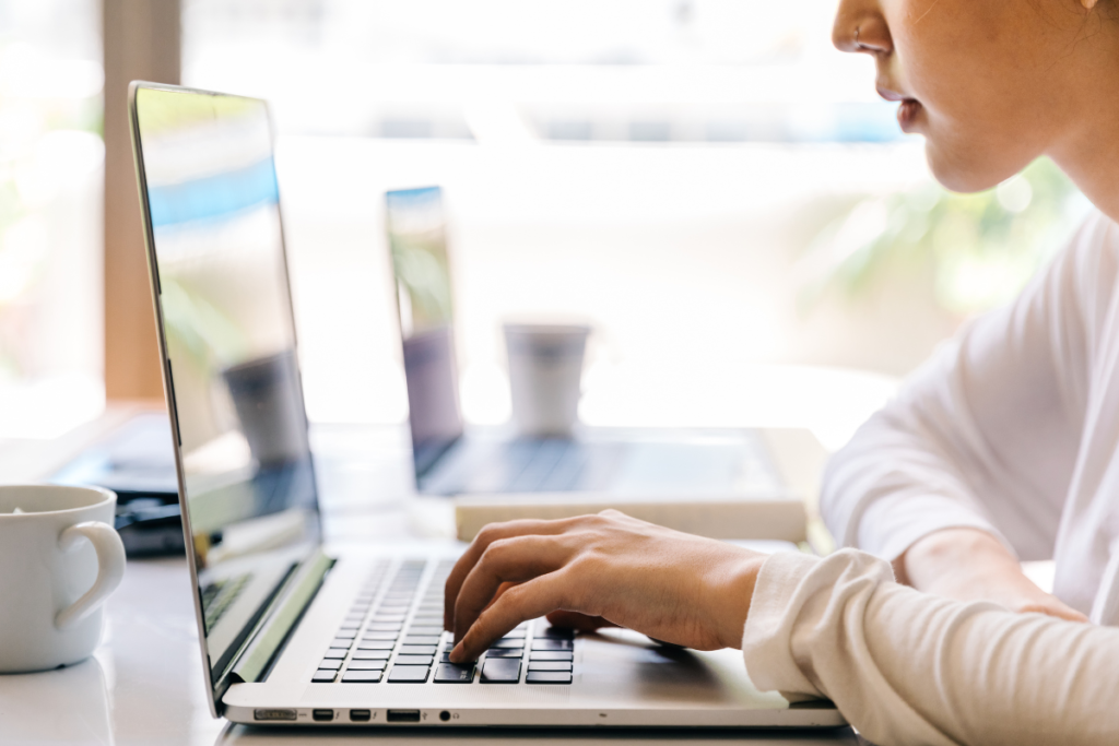 Woman thoughtfully looking at her laptop, weighing options for SEO strategies