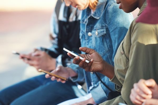 Friends scrolling through their own phone