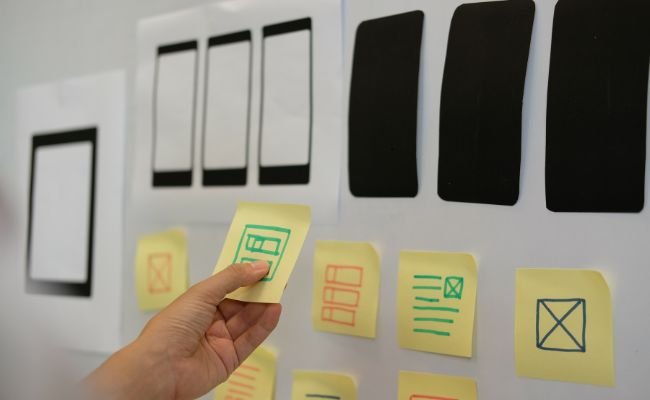 A web designer creating wireframes for mobile web design.