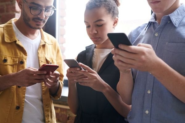 Phone users heavily engaged on their phones.