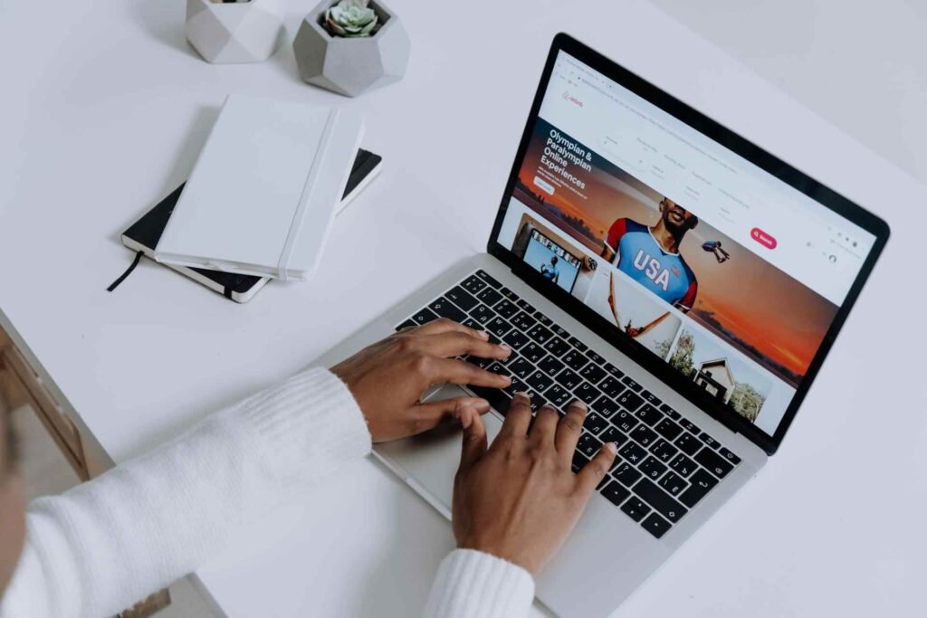 a man looking at the web design on a laptop