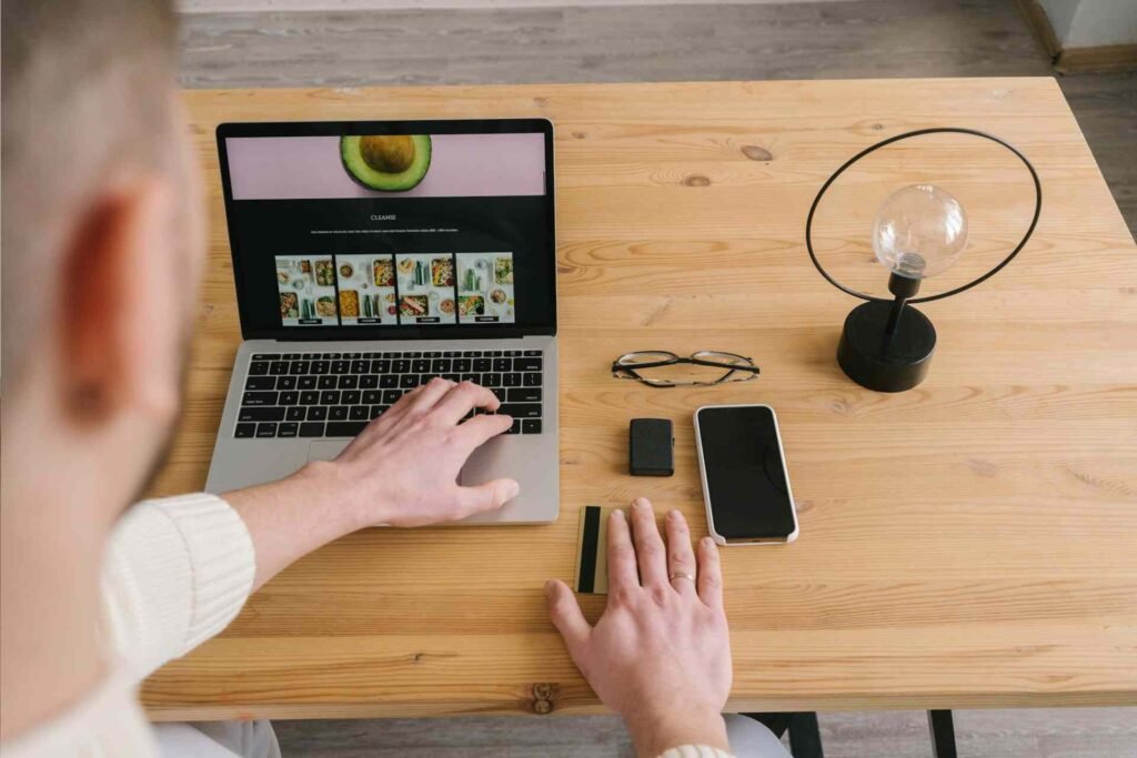 a man working web design on a laptop