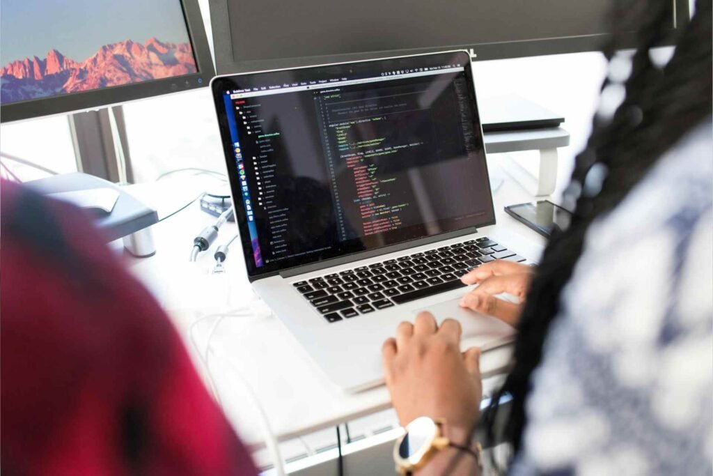 a developer coding on a laptop