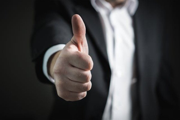 a man thumbs up in business industry