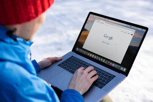 person in blue jacket browsing in google search