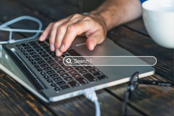 man searching on the web using his laptop