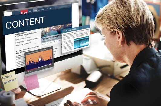 Content SEO specialist developing strategic framework on computer for optimization planning.