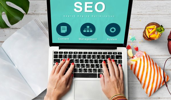 Hands typing on laptop demonstrate what is SEO marketing categories