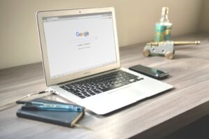 Laptop showing Google search page explaining what SEO agencies do for businesses.
