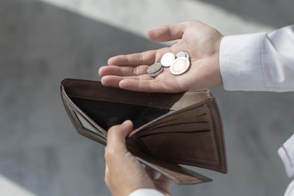 A man taking out a few coins.