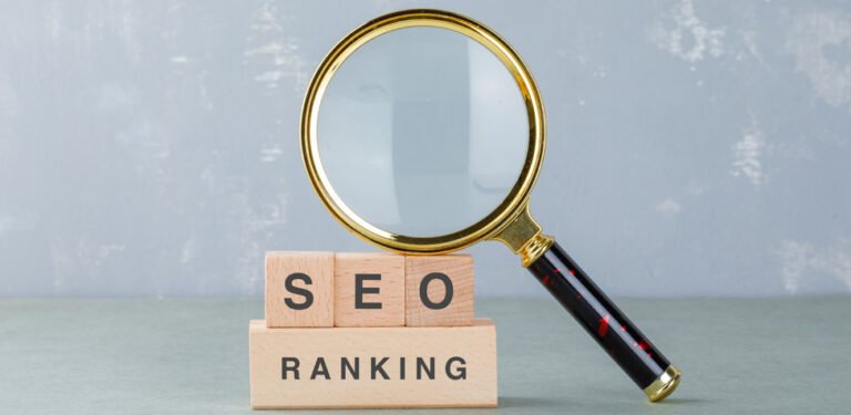 Wooden blocks SEO ranking with magnifying glass showing The 3 C's Of SEO.
