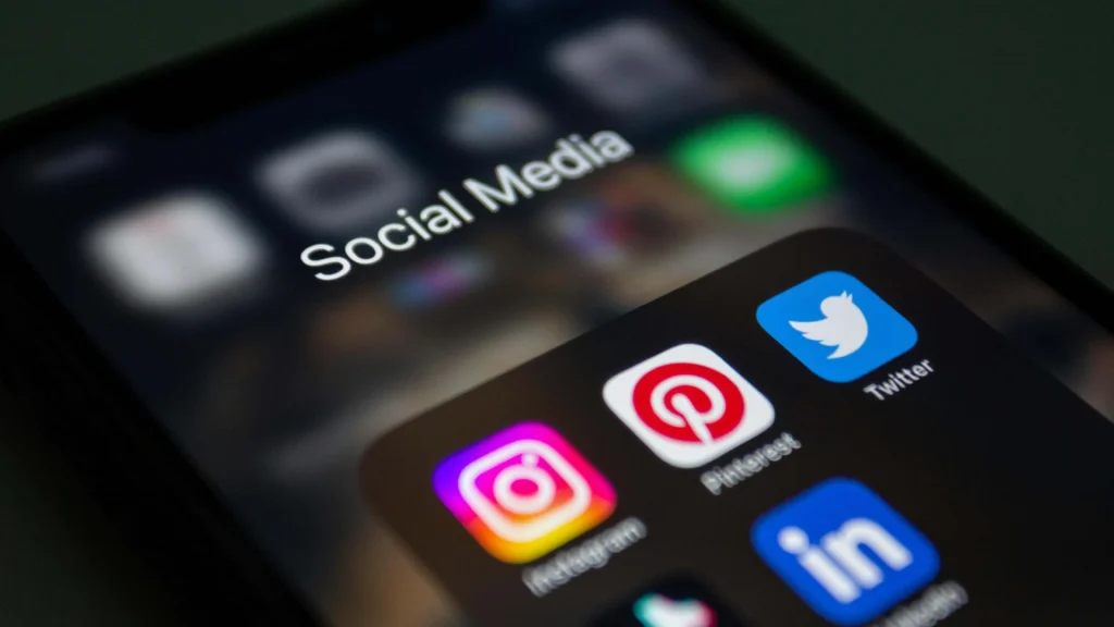 Phone screen displaying Facebook LinkedIn and Instagram for social media marketing