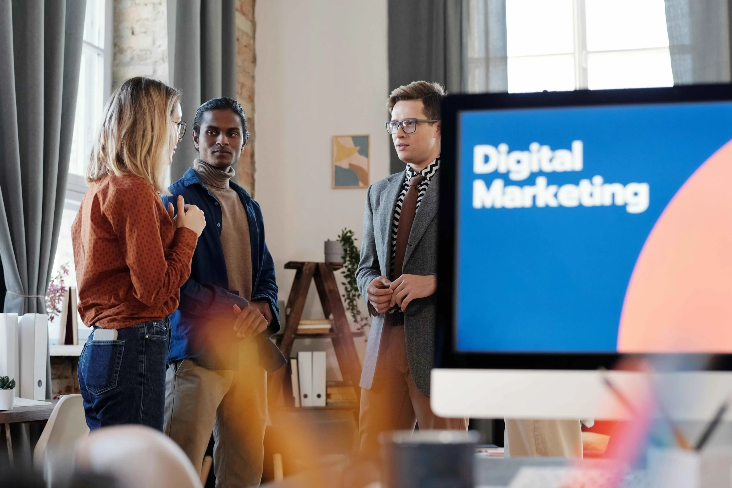 Marketing team reviewing digital marketing campaign analytics