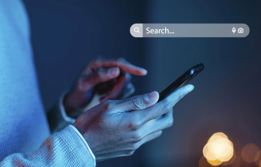 Is SEO Dead In 2026? What The Data Actually Shows 3 Person searching something online using a phone proving SEO is not dead