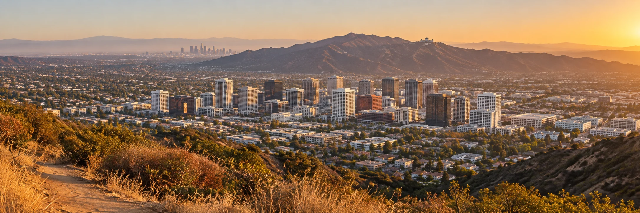 Panoramic view of Glendale, California from the Verdugo Mountains, looking over the downtown towers toward Griffith Park at golden hour